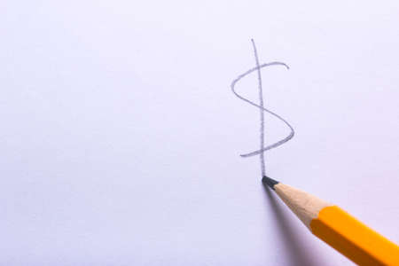 Dollar sign penciled on white paper. Empty space for textの写真素材
