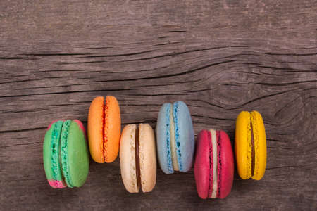 Cake macaron or macaroon colorful cookies. On an old wooden background. Empty space for textの写真素材