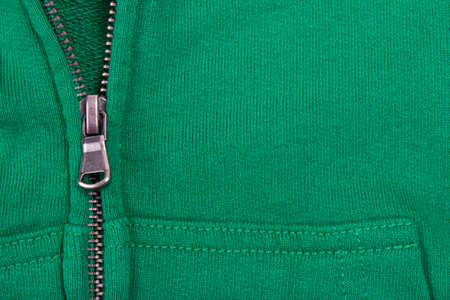 Close up of Zipper  partly open. On a green backgroundの写真素材