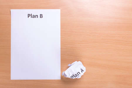 Crumpled paper Plan A and clean sheet Plan B on a wood  backgroundの写真素材