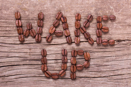 wake up words from coffee on old wooden tableの写真素材