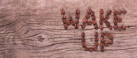 wake up words from coffee on old wooden tableの写真素材