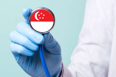 Medicine in Singapore is free and paid. Expensive medical insurance. Treatment of disease at the highest level Doctor holding a stethoscope in his handの写真素材