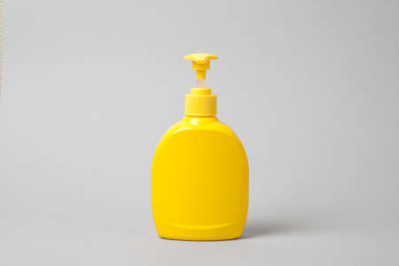 Hygienic cream liquid soap in  yellow plastic bottle.  mockupの写真素材