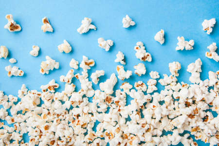 Popcorn scattered on blue backgroundの写真素材