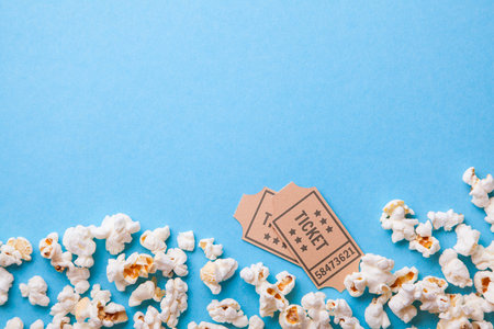 Movie tickets and popcorn on blue background. Copy space for textの写真素材