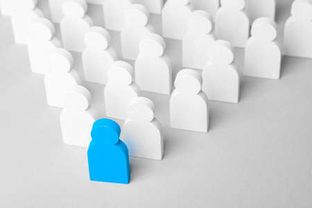Concept leader of the business team indicates the direction of the movement towards the goal. Crowd of white men goes for the leader of the blue colorの写真素材