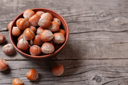 Hazelnut to plate on an old wooden table.. Copy space for text