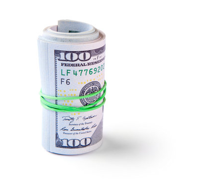 100 dollar bills twisted into tube and tied with an elastic band. Isolated on white background.