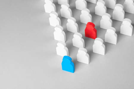 Concept leader of the business team indicates the direction of the movement towards the goal. Crowd of white men goes for the leader of the blue color and  bad conflicting employee of  red colorの写真素材