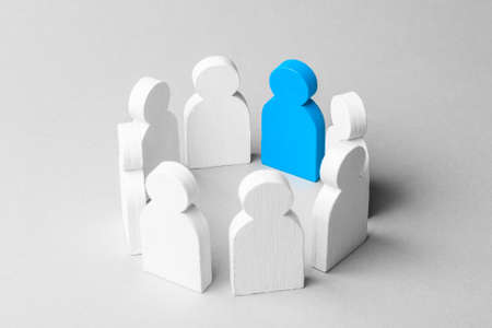 Concept leader of  business team. Crowd of white men stands in  circle and listens to the leader of the blue colorの写真素材