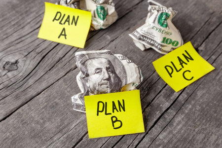 Failed business plan A, B and C. Minted dollar banknotes on a wooden desk. Concept