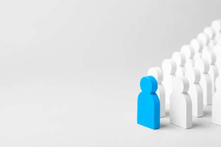 Concept leader of the business team indicates the direction of the movement towards the goal. Crowd of white men goes for the leader of the blue color. Copy space for textの写真素材