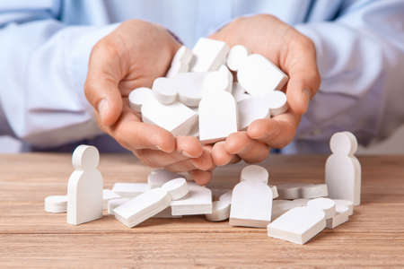 Choosing a good leader worker from the crowd of bad. HR. Man in the palms holds  lot of peopleの写真素材