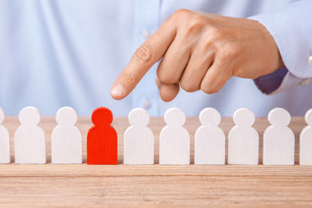 Choosing a good leader worker from the crowd of bad. HR. Man in  shirt points  finger at a good worker.の写真素材