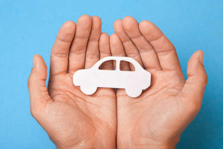 Car insurance. Man is holding car.の写真素材