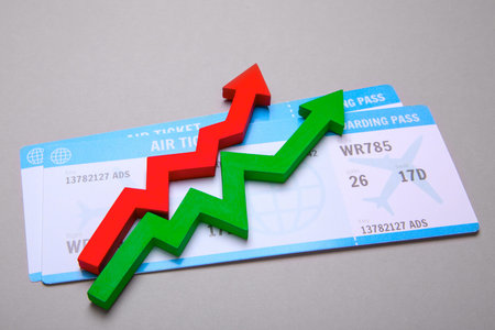 Two plane tickets and red and green arrow up. Increase in sales of air tickets in seasonの写真素材