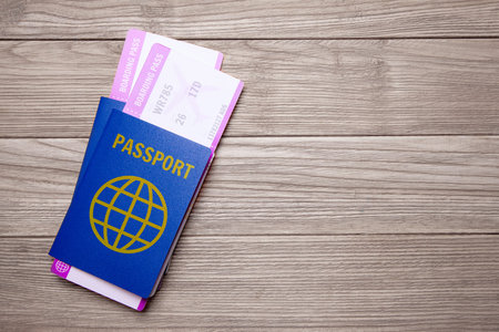 Two tickets for a plane with passports on an old wooden table. Copy space for textの写真素材