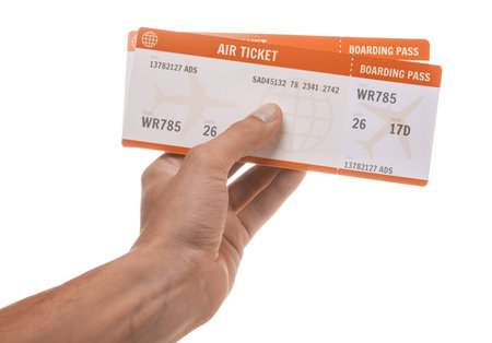 Man is holding two tickets for the plane. Isolated on white background