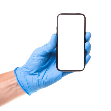 Doctor in blue glove is holding  touchscreen smartphone in his hands. Isolated on white backgroundの写真素材