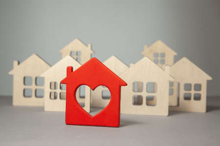 Search and selection of homes for purchase or rent. Many house models and one red with heartの写真素材