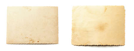 Stack old photos isolated on white background. Mock-up blank paper. Postcard rumpled and dirty vintage. Retro cardの写真素材