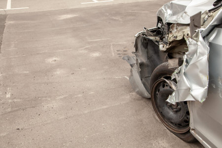 Crash car in front after the accident. Broken wing and wheel, bumper and undercarriage. Copy space for textの写真素材