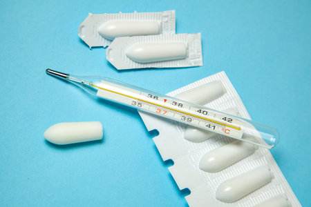 Suppository for anal or vaginal use and thermometer. Candles for treatment of high temperature.