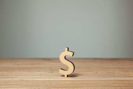 Dollar symbol made of wood on a wooden table.の写真素材