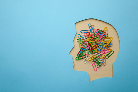 Head busy with work or office affairs. In the head of man office clips. Copy space for text.