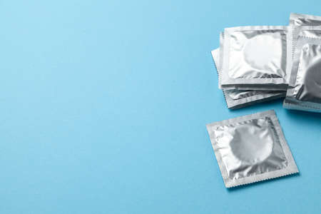 Condoms in pack on blue background. Copy space for textの写真素材