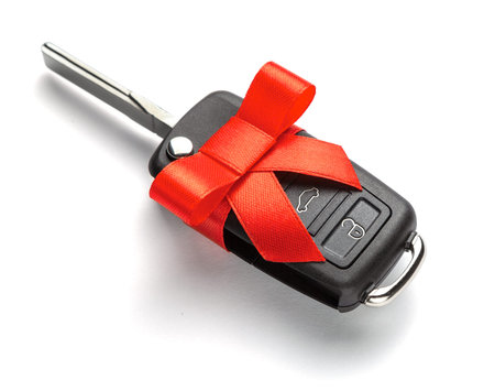 Gift Car keys with remote control alarm with red ribbon with bow. Isolated on white background