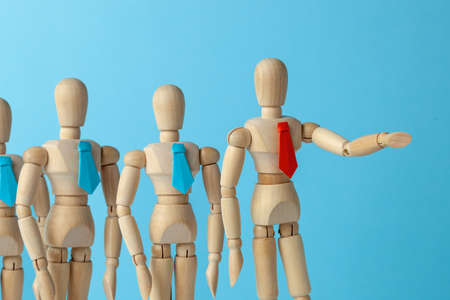 The leader shows the way for the business team to good goal. The leader in red tie shows the direction of his hand business team in blue tiesの写真素材