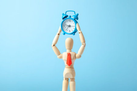 Time management. Man in tie holds an alarm clock in his hand