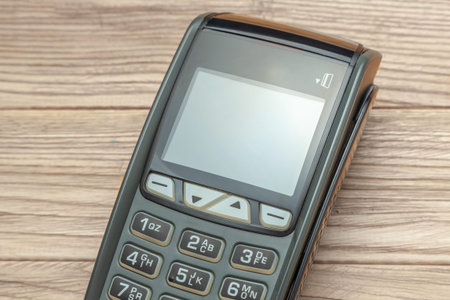 POS terminal, Payment Machine on wooden background. Contactless payment. NFC technology
