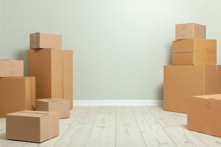 Day moving. Delivery of goods, shopping. Cardboard boxes on gray wall background. Copy space for textの写真素材