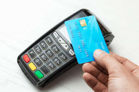 POS terminal, Payment Machine with credit card on white background. Contactless payment with NFC technologyの写真素材