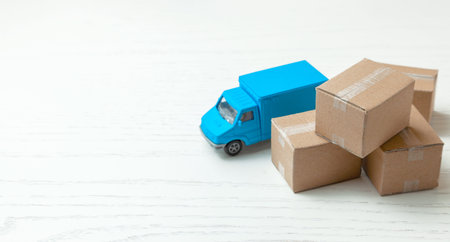 Delivery of goods from online stores. Day moving. Truck and cardboard boxes. Copy space for textの写真素材