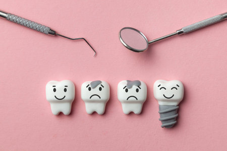 Healthy white teeth and implant are smiling and the tooth is sick with caries sad on pink...