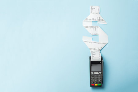 Terminal cash register machine POS for payments and long roll paper cash tape in shape of dollar...