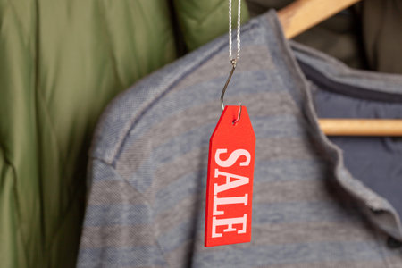 Red tag on the clothes with the inscription sale on the fishing hookの写真素材