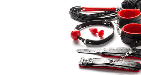 Set of erotic toys for BDSM. The game of sexual slavery with handcuffs, whip, gag and leather...