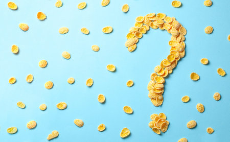 Yellow flakes in the shape of a question mark on a blue background. How to choose cereal for...
