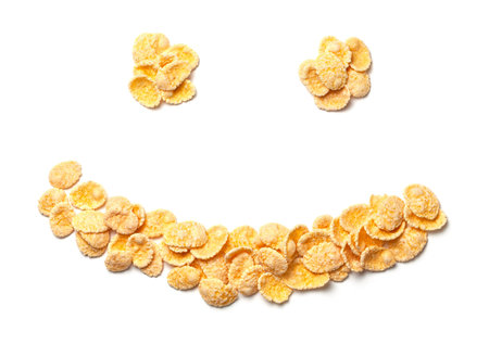 Yellow corn flakes symbol face with smile isolated on white background.