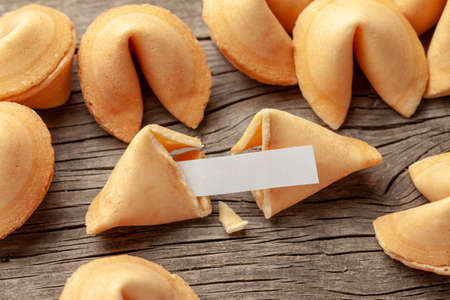 Chinese fortune cookies. Cookies pile with blank blank inside for words prediction. Background of old wooden tableの写真素材