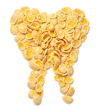 Yellow corn flakes symbol tooth isolated on white background.の写真素材
