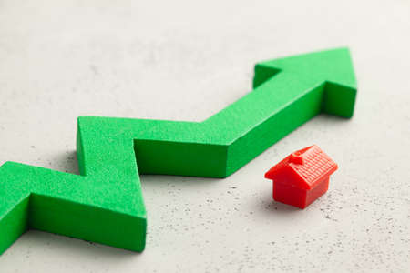 House and red up arrow. Rising real estate prices. Raising insurance or tax ratesの写真素材