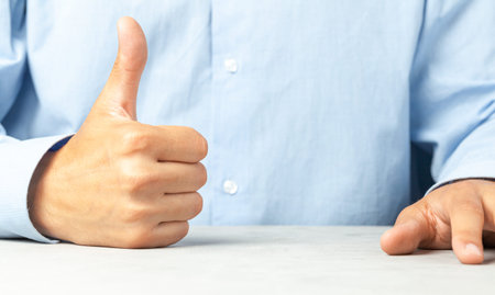 Businessman in shirt showing thumbs up, like. Copy space for text