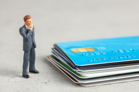 Businessman in a suit and credit cards. Concept of choosing a credit card or paying debts or bills.
