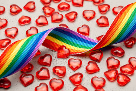LGBT rainbow ribbon and hearts. Pride tape symbol. Grey background.の写真素材